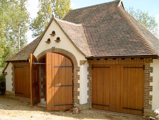 Three pairs of cedar wood barn style side hinged garage doors